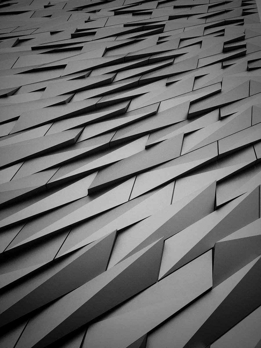 Grey angular building facade with staggered projecting balconies