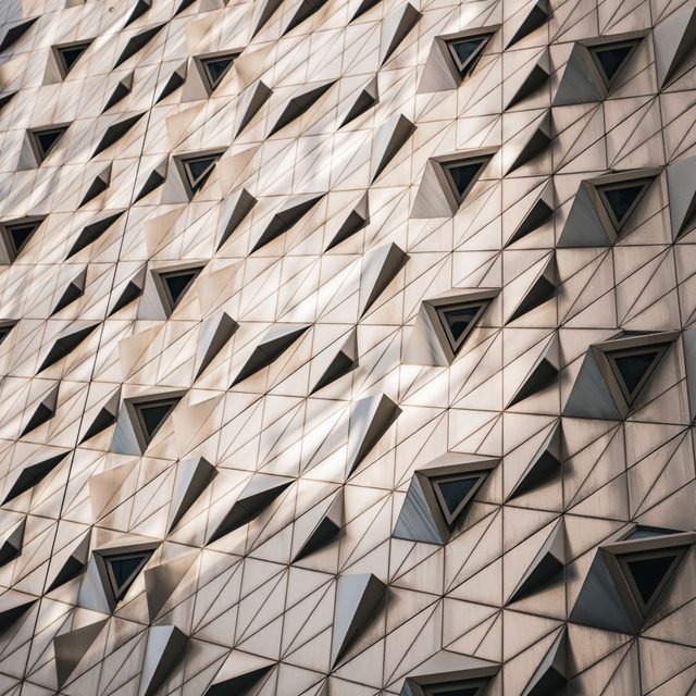 Textured relief facade of repeating angular panels