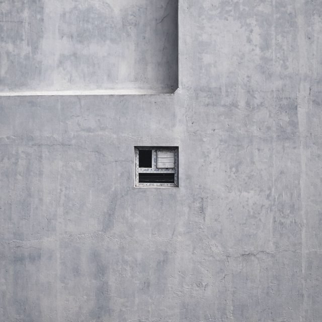 Bare concrete wall with a single recessed window